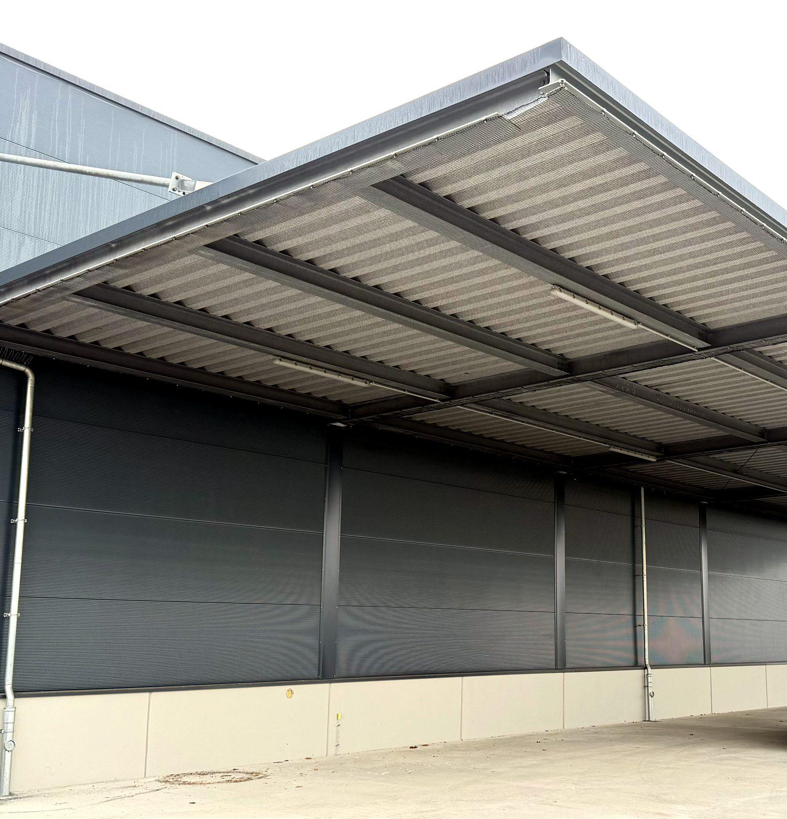 Pigeon netting fully installed under the canopy of a logistics hall