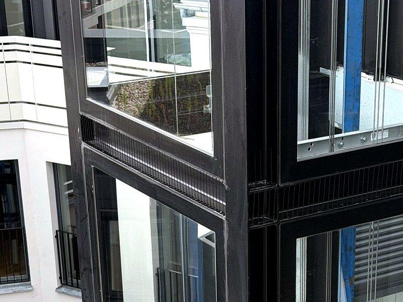 Close-up of pigeon deterrent spikes on a beam of an elevator shaft